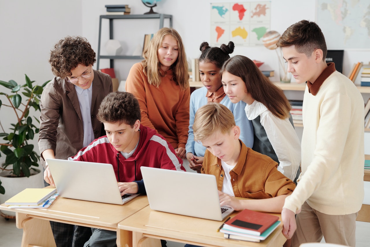 children using laptops in classroom